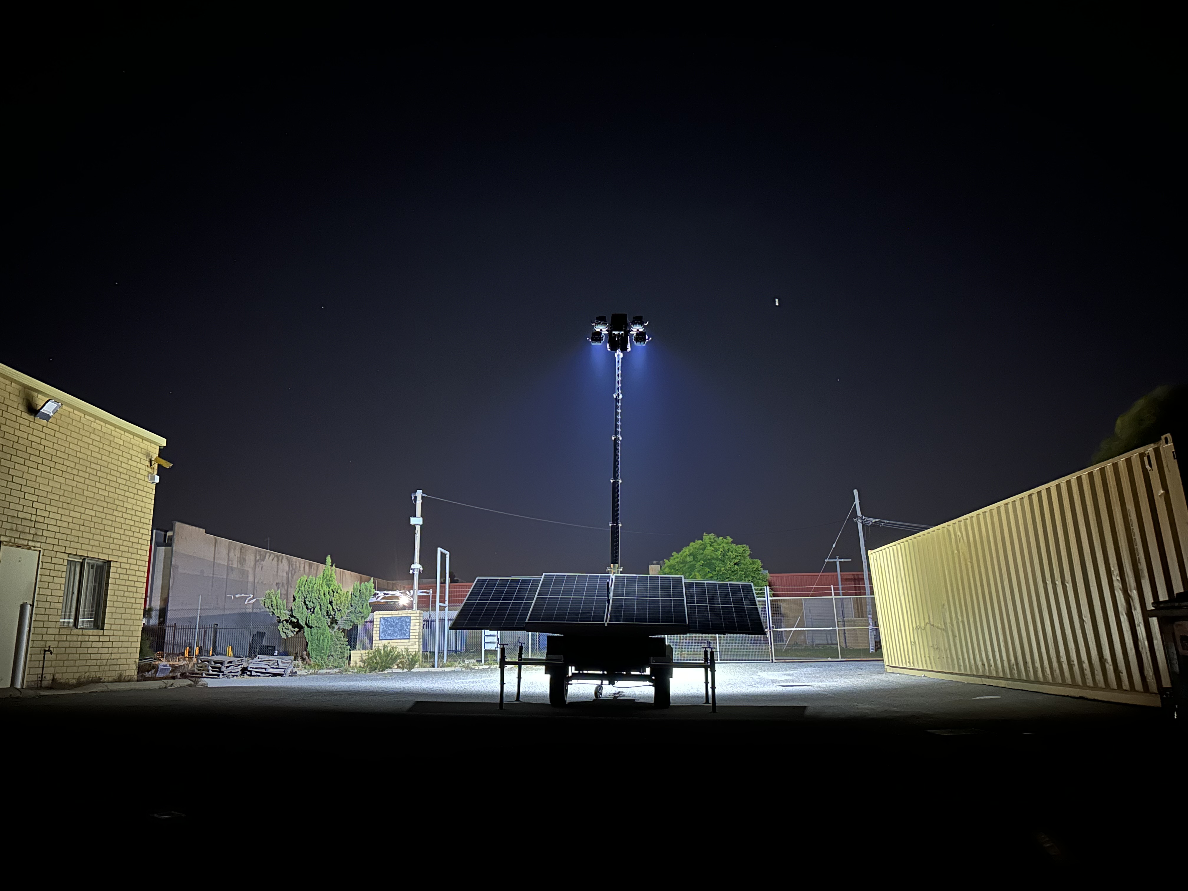 Indigenous business Kabanji's X-Solar Lighting Tower. Lighting Tower extended with lights on, lighting up a yard. Sustainable Lighting tower utilising battery and solar power.